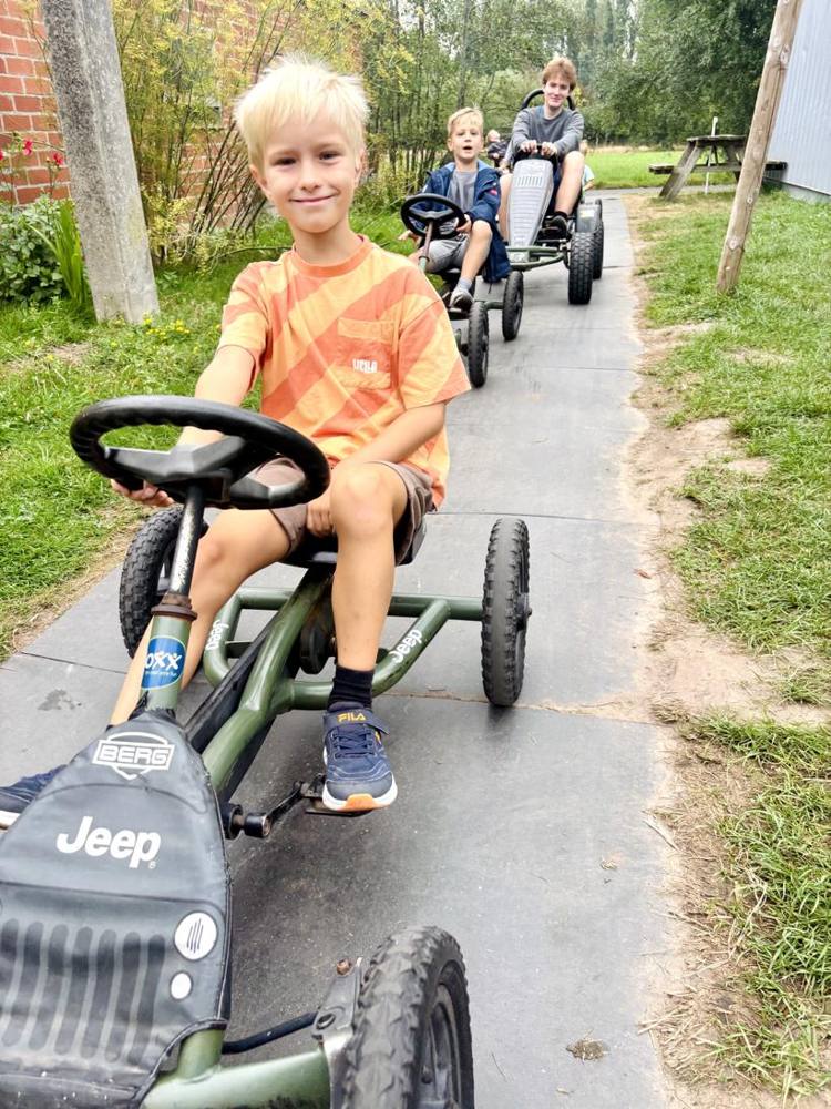 Kinderen rijden met go-carts op de boerderij